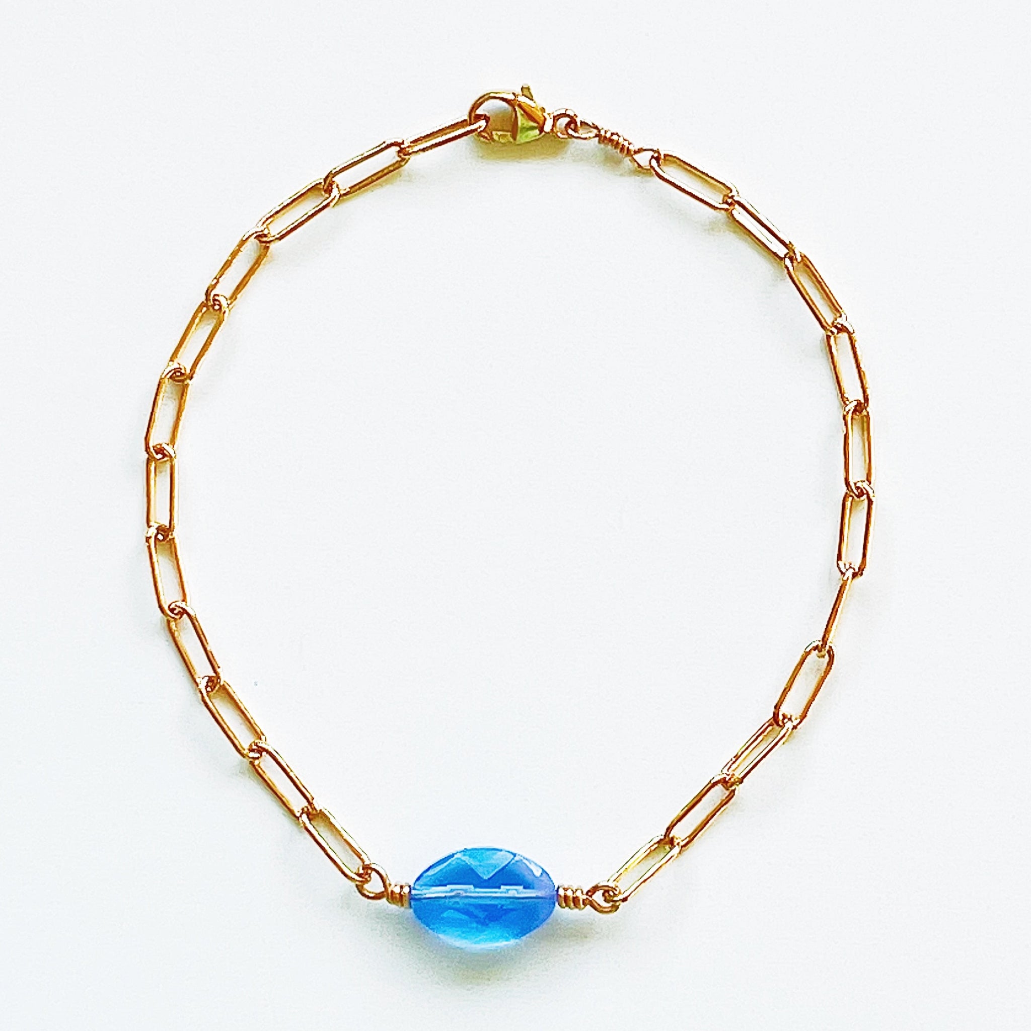 Adjustable 7.5" gold-filled paperclip chain bracelet featuring a cushioned shaped blue opalite stone.