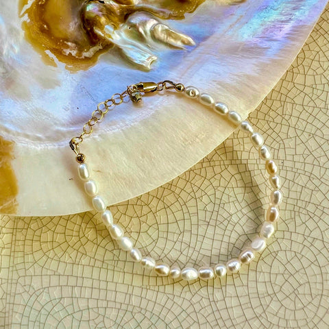 Single strand white, rice freshwater pearl bracelet with 1" adjustable chain