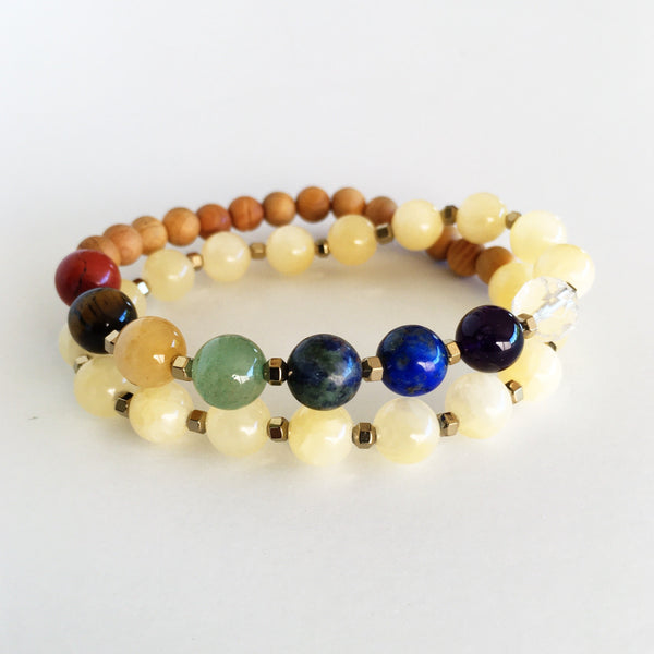 This double wrap stretchy mala bracelet contains 27, 8 mm gemstones & sandalwood beads. Of which are 7 round smooth chakra gemstones, 1 round faceted clear crystal quartz gemstone, and 19 round smooth natural yellow jade gemstones. Gemstones are separated by 2mm Hematite Hexagon spacer beads. 6mm sandalwood beads are used to complete to complete the design.