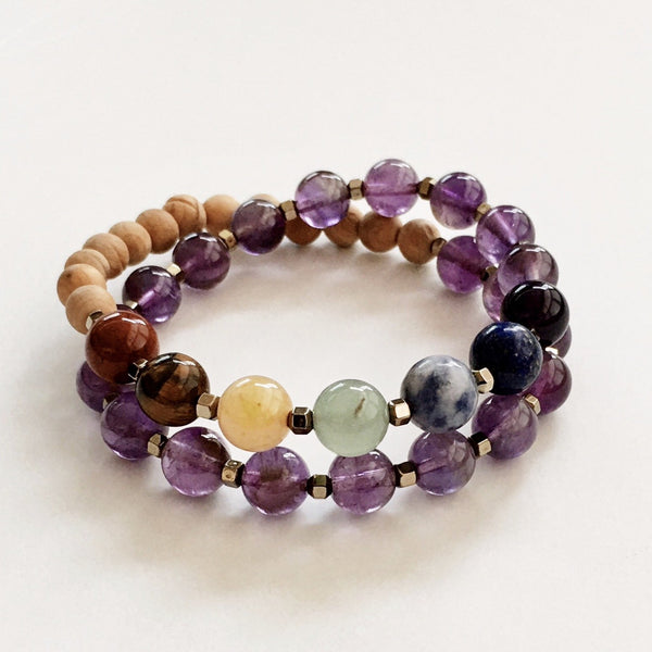 This double wrap stretchy mala bracelet contains 27, 8 mm gemstones & sandalwood beads. Of which are 7 round smooth chakra gemstones, and 20 round smooth amethyst gemstones. Gemstones are separated by 2mm Hematite plated spacer beads. 6mm round smooth sandalwood beads are used to complete the quarter mala bracelet design.