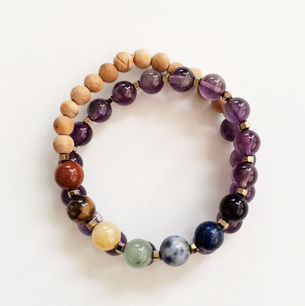 This double wrap stretchy mala bracelet contains 27, 8 mm gemstones & sandalwood beads. Of which are 7 round smooth chakra gemstones, and 20 round smooth amethyst gemstones. Gemstones are separated by 2mm Hematite plated spacer beads. 6mm round smooth sandalwood beads are used to complete the quarter mala bracelet design.