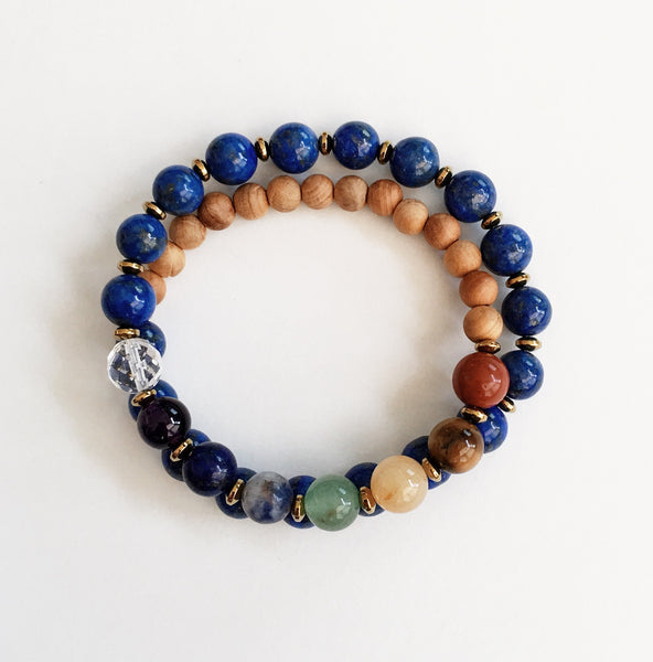 This double wrap stretchy mala bracelet contains 27, 8 mm gemstones & sandalwood beads. Of which are 7 round smooth chakra gemstones, 1 round faceted clear crystal quartz gemstone, and 19 round smooth lapis lazuli gemstones. Gemstones are separated by 2mm Hematite plated spacer beads. 6mm round smooth sandalwood beads are used to complete the quarter mala bracelet design.