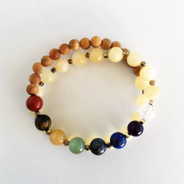 This double wrap stretchy mala bracelet contains 27, 8 mm gemstones & sandalwood beads. Of which are 7 round smooth chakra gemstones, 1 round faceted clear crystal quartz gemstone, and 19 round smooth natural yellow jade gemstones. Gemstones are separated by 2mm Hematite Hexagon spacer beads. 6mm sandalwood beads are used to complete to complete the design.